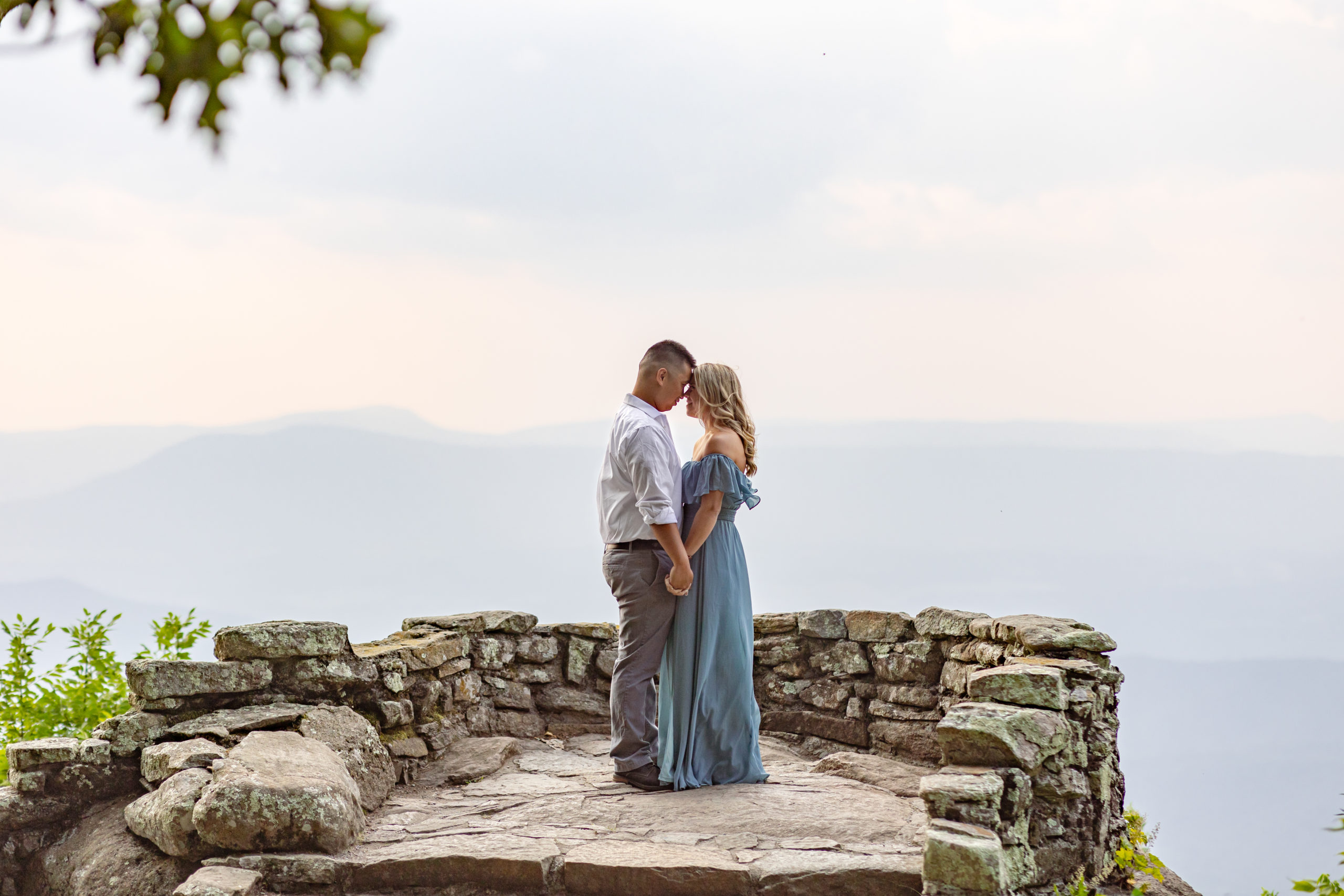 A couple standing at the overlook on the Blue Ridge Parkway in Bedford, Virginia.