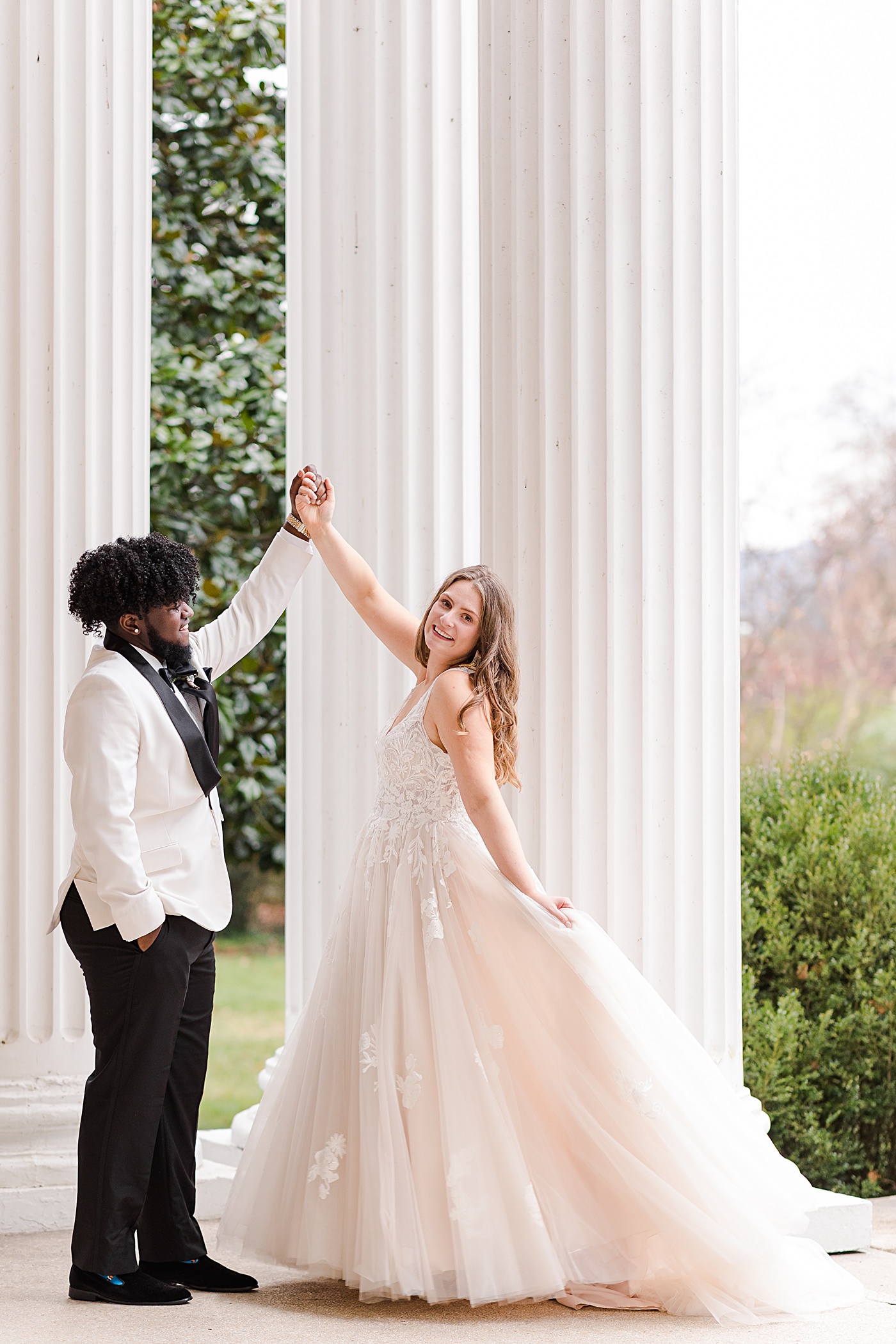 Groom twirling his bride for a portrait at their New Years Eve Roanoke, Virginia Wedding.