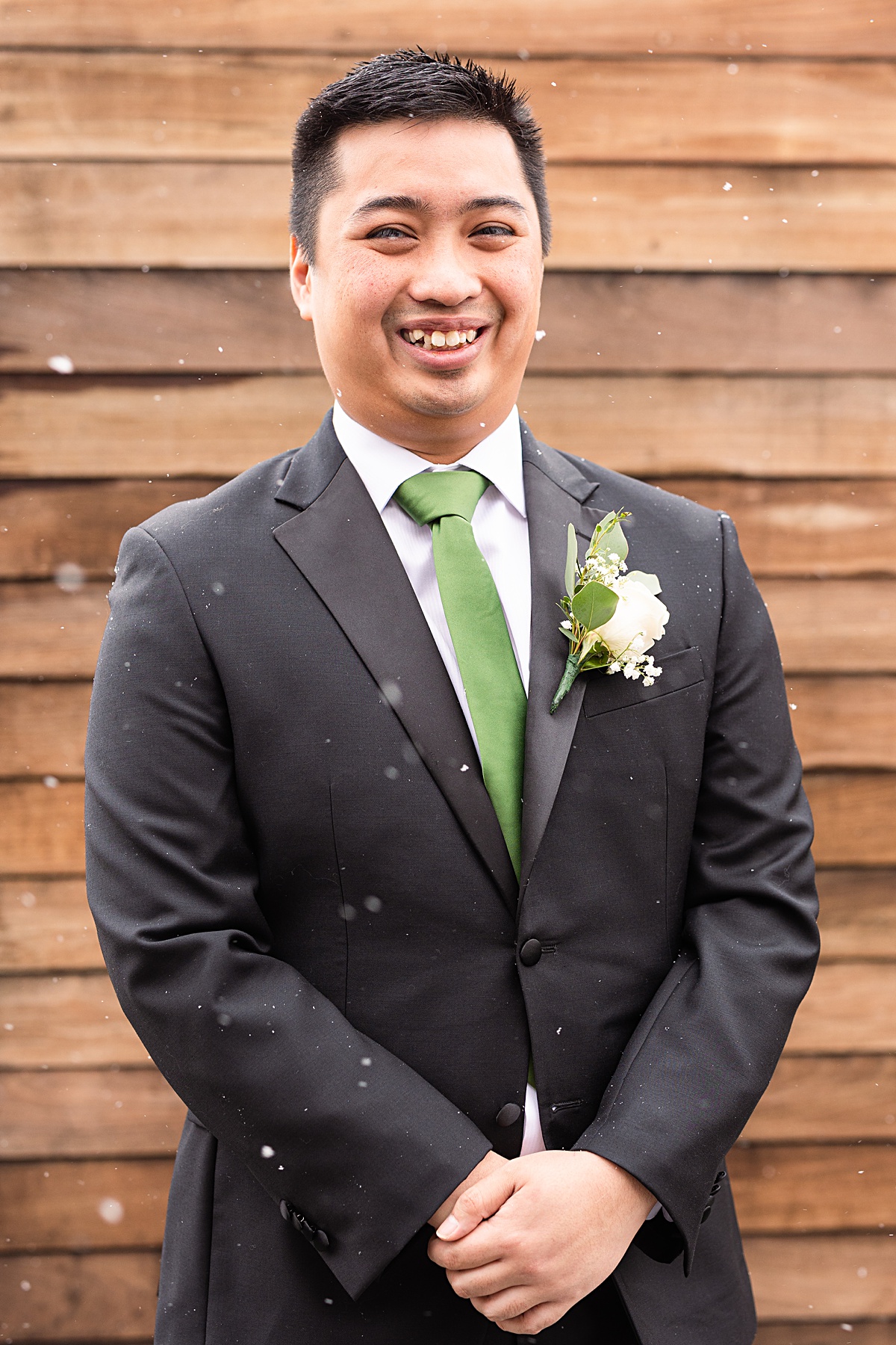 Groom portrait in the snow fall on the Skyline rooftop at The Virginian Hotel in Lynchburg, Virginia.