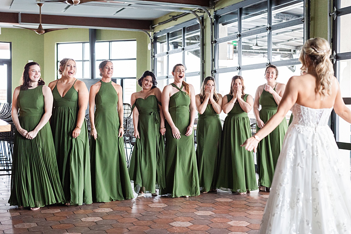 First look reaction photo with bridesmaids and the bride at The Virginian Hotel in Lynchburg, Virginia.