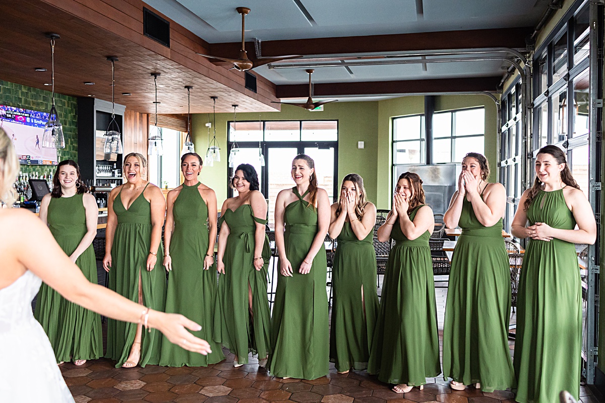 First look reaction photo with bridesmaids and the bride at The Virginian Hotel in Lynchburg, Virginia.