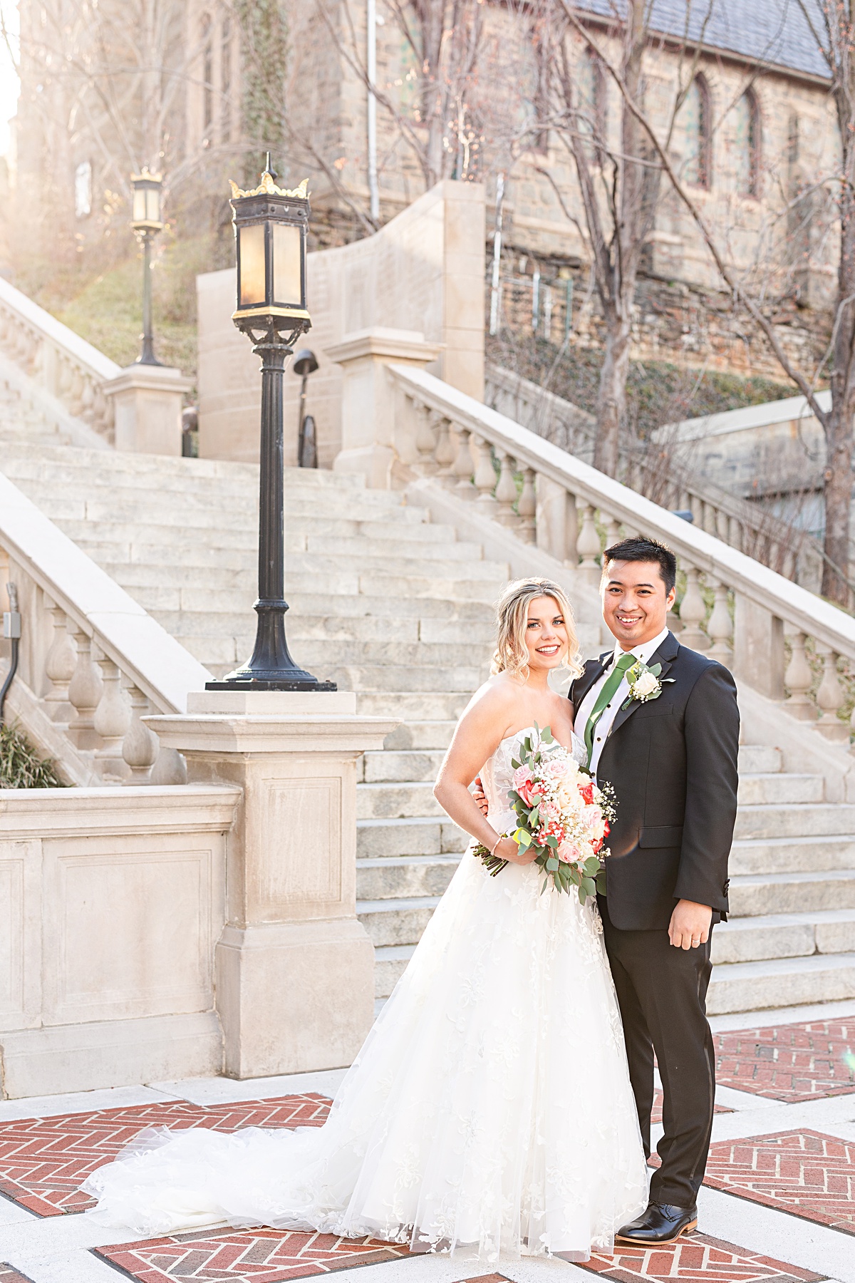 Portrait of the bride and groom on the stairs of Monument Terrace in Downtown Lynchburg before their ceremony at The Virginian Hotel in Lynchburg, Virginia.