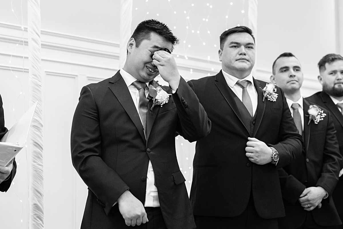 The groom crying at the alter as his bride entering the ceremony at The Virginian Hotel in Lynchburg, Virginia.