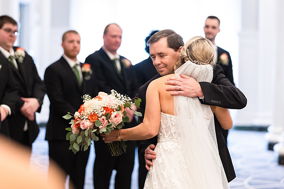 Father of the bride giving her away at the ceremony at The Virginian Hotel in Lynchburg, Virginia.