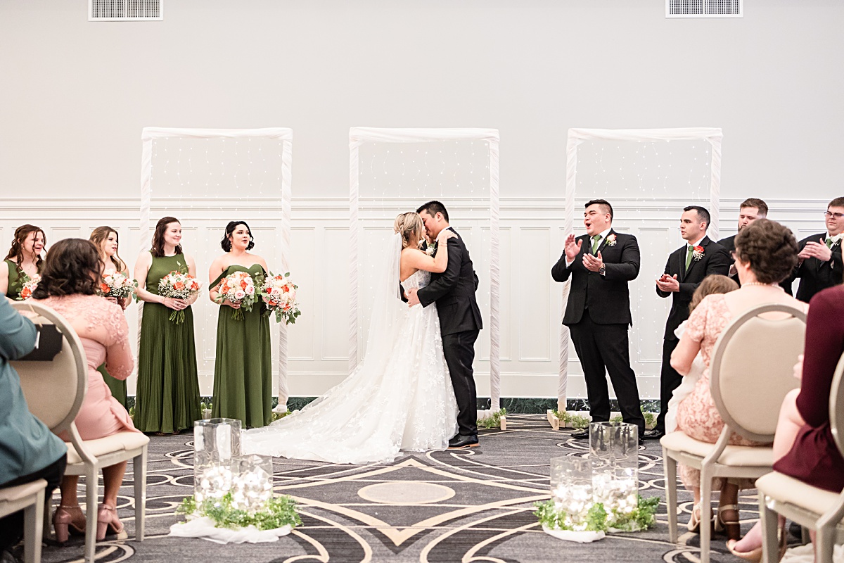 Ceremony photo of the bride and groom sharing their first kiss as husband and wife at their The Virginian Hotel wedding in Lynchburg, Virginia.