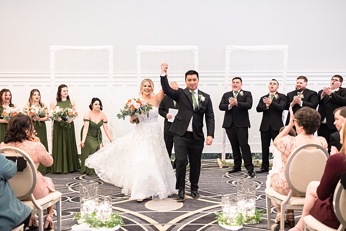 Ceremony photo of the bride and groom sharing their first kiss as husband and wife at their The Virginian Hotel wedding in Lynchburg, Virginia.