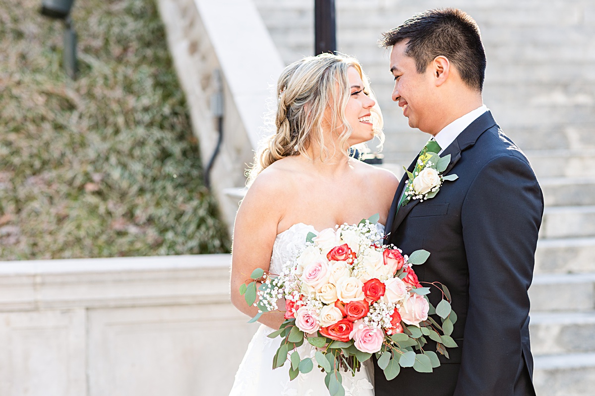 Portrait of the bride and groom on the stairs of Monument Terrace in Downtown Lynchburg at The Virginian Hotel in Lynchburg, Virginia.