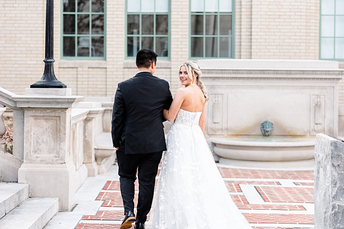 Portrait of the bride and groom on the stairs of Monument Terrace in Downtown Lynchburg at The Virginian Hotel in Lynchburg, Virginia.