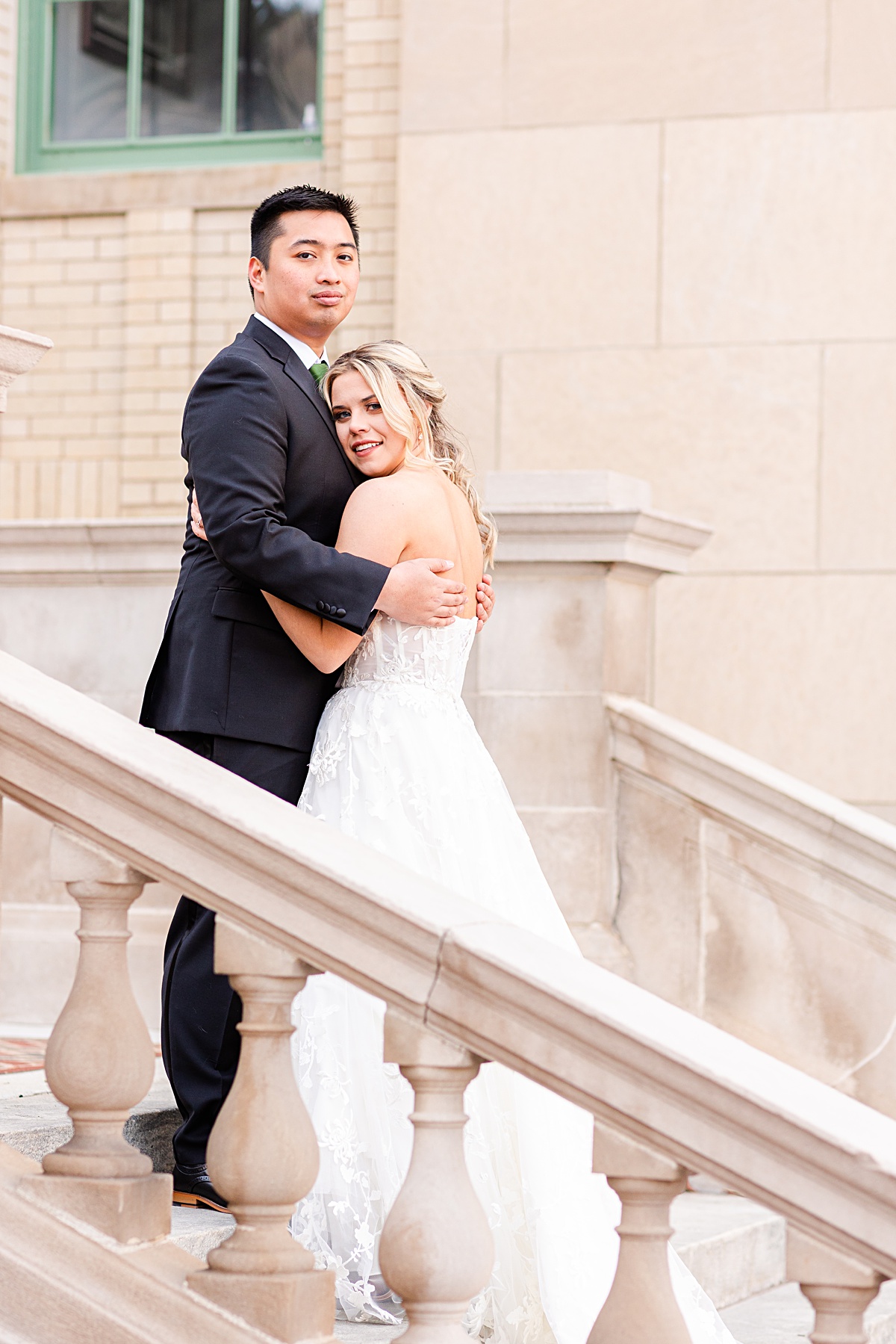 Portrait of the bride and groom on the stairs of Monument Terrace in Downtown Lynchburg at The Virginian Hotel in Lynchburg, Virginia.