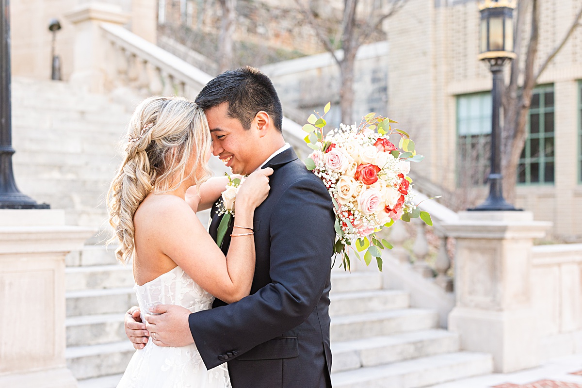 Portrait of the bride and groom on the stairs of Monument Terrace in Downtown Lynchburg at The Virginian Hotel in Lynchburg, Virginia.