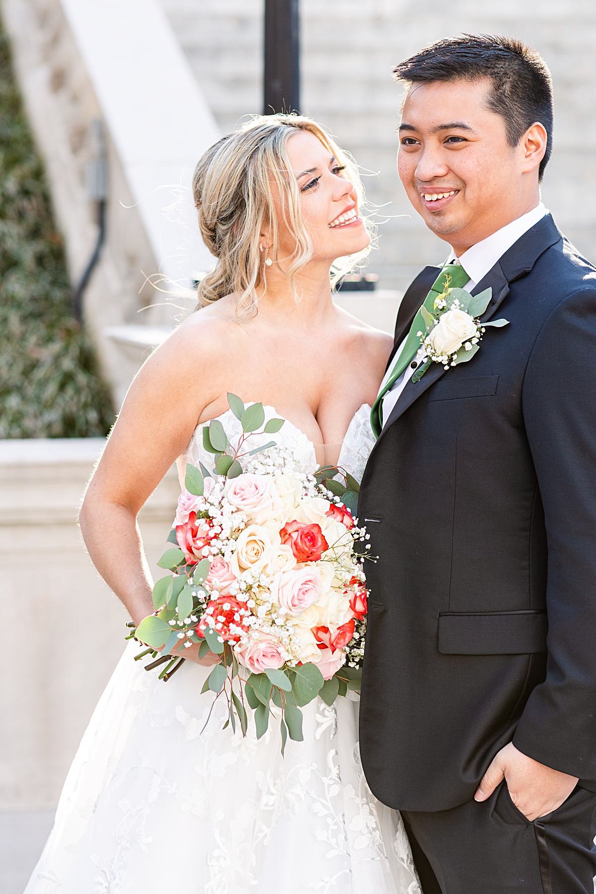 Portrait of the bride and groom on the stairs of Monument Terrace in Downtown Lynchburg at The Virginian Hotel in Lynchburg, Virginia.