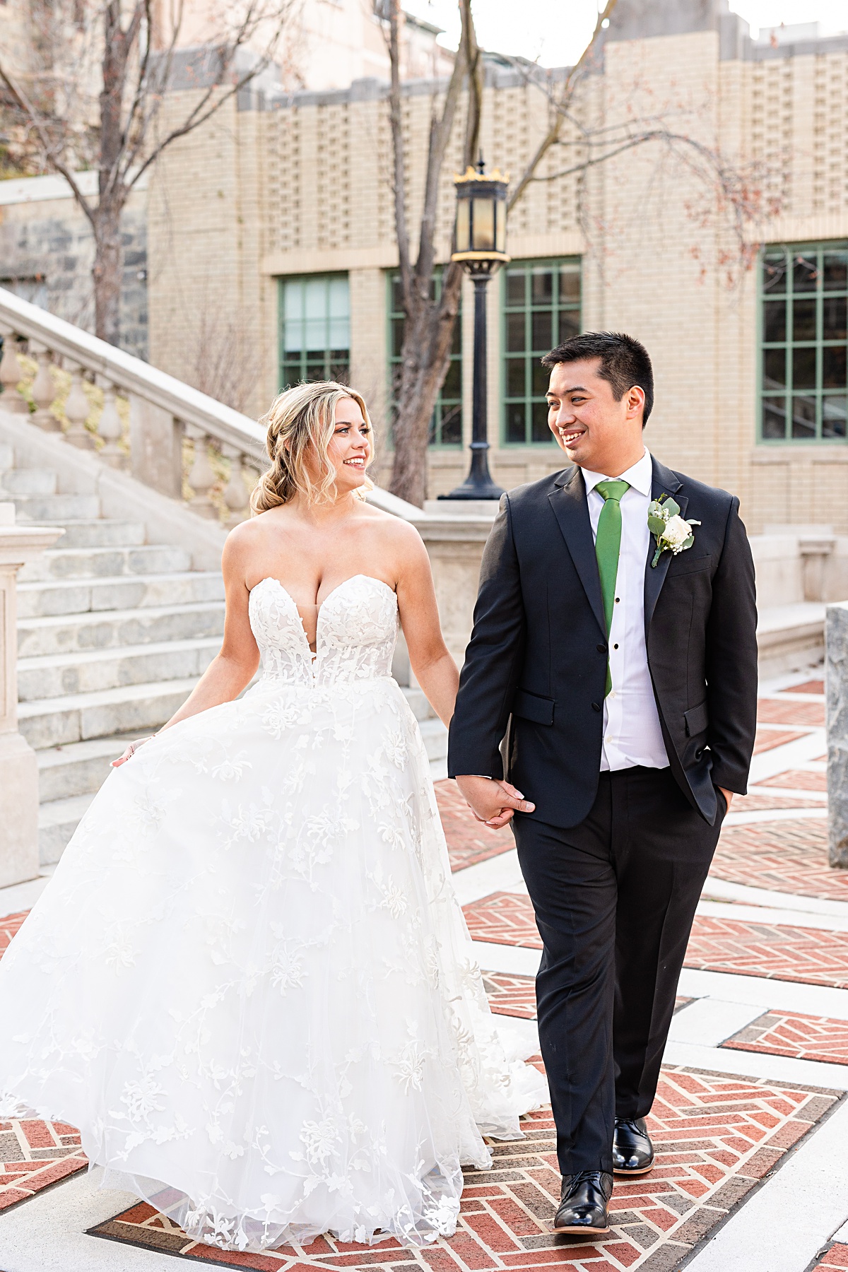 Portrait of the bride and groom on the stairs of Monument Terrace in Downtown Lynchburg at The Virginian Hotel in Lynchburg, Virginia.