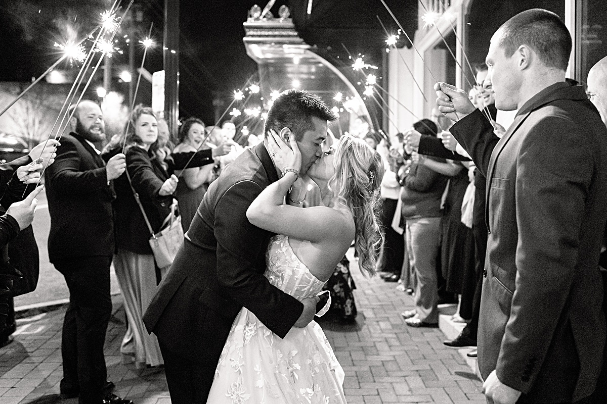 Bride and groom sharing a kiss at their sparkler exit at The Virginian Hotel in Lynchburg, Virginia.