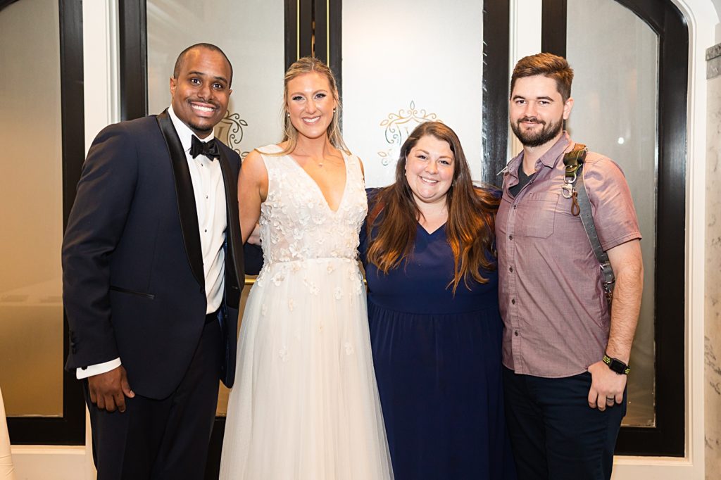 Emily Hancock Photography team group photo with the bride and groom at this ballroom wedding at the Virginian Hotel in Lynchburg, Virginia.