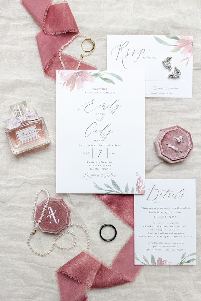 Invitation Suite and bridal details photo with dusty rose wedding colors and elegant engraved ring box.