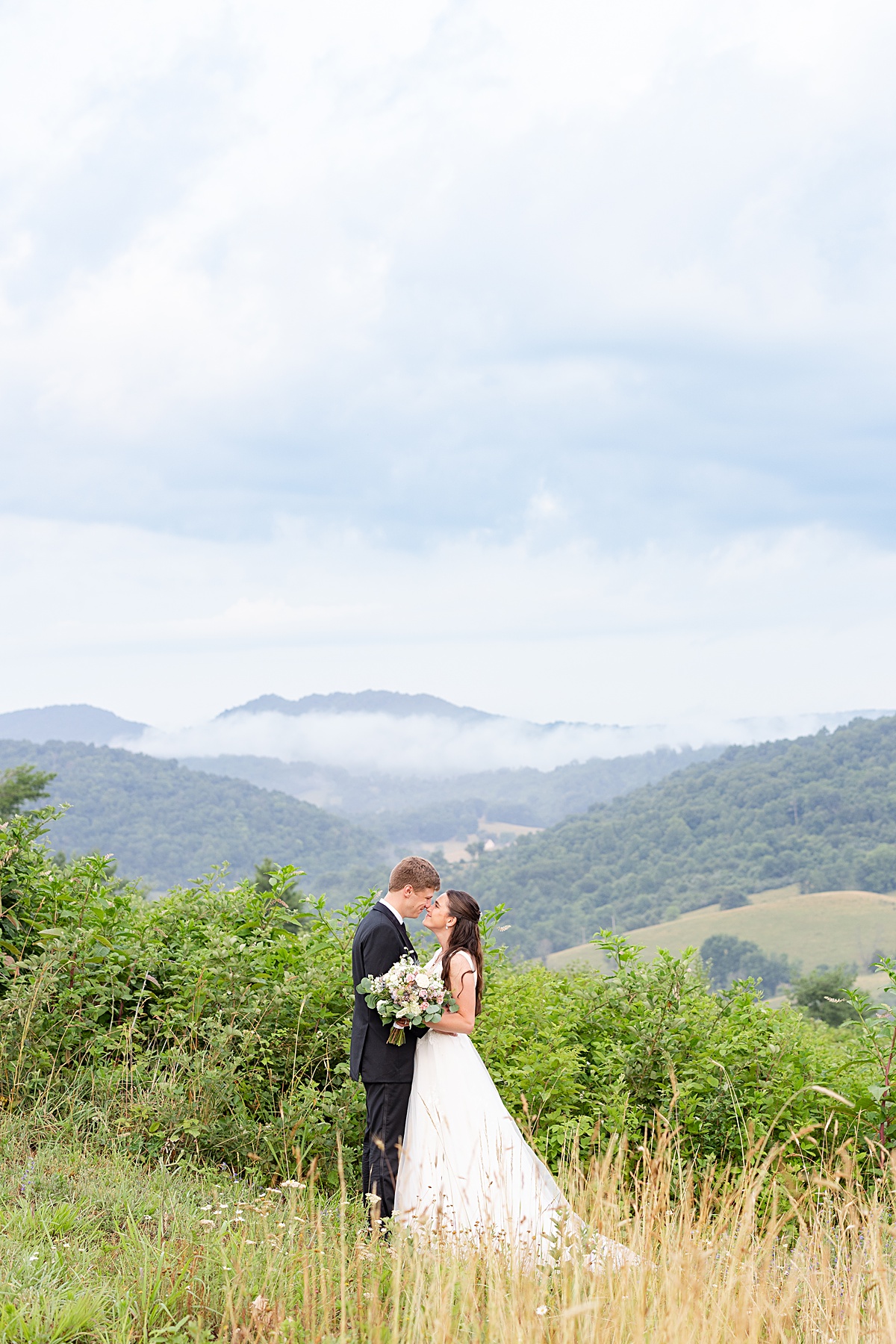 Bride and groom portrait at their sunset portraits after a thunderstorm at Walker Creek Barn in Pembroke, Virginia.