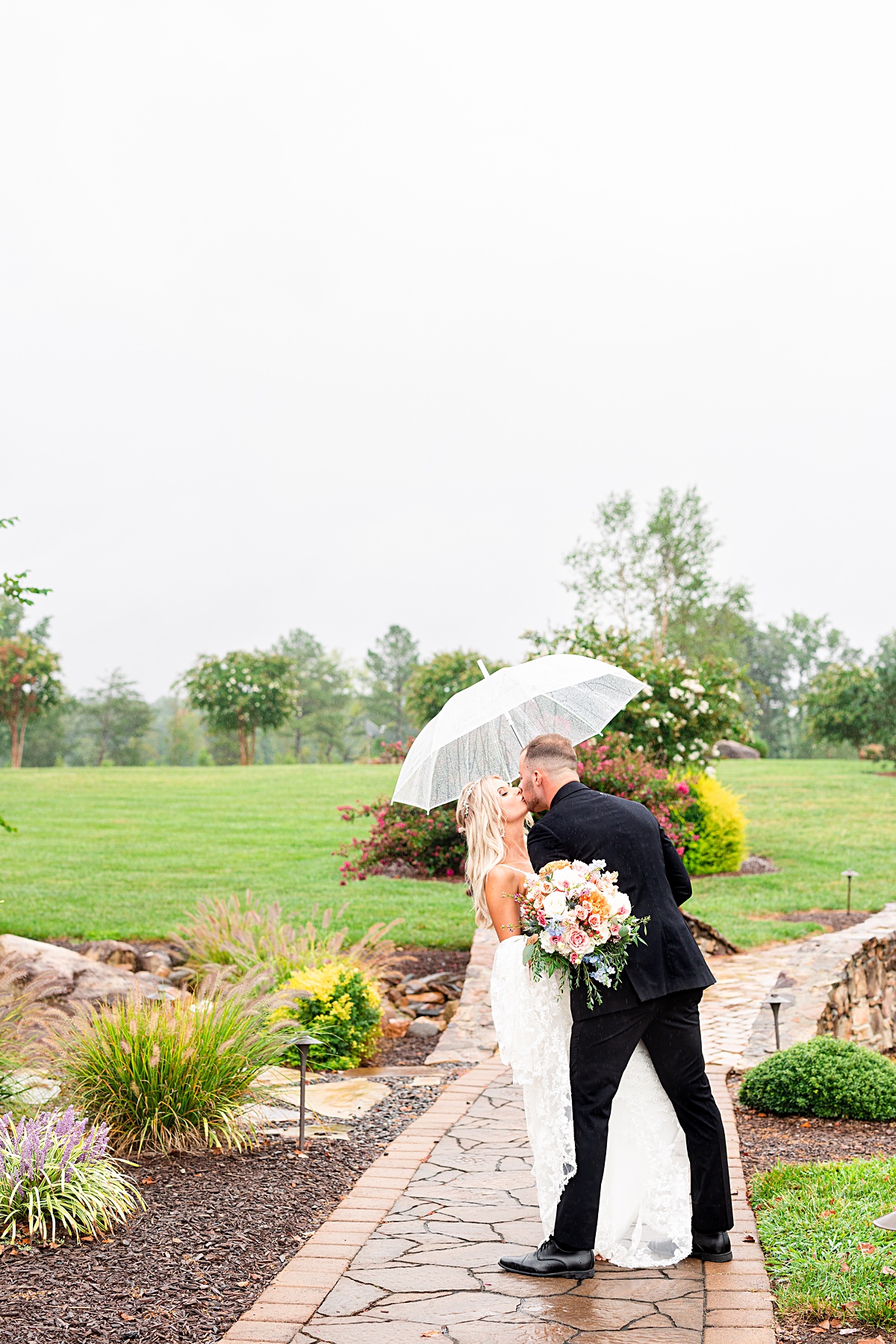 Bride and Groom portrait in the rain at their Atkinson Farms Rainy Wedding in Danville, Virginia.