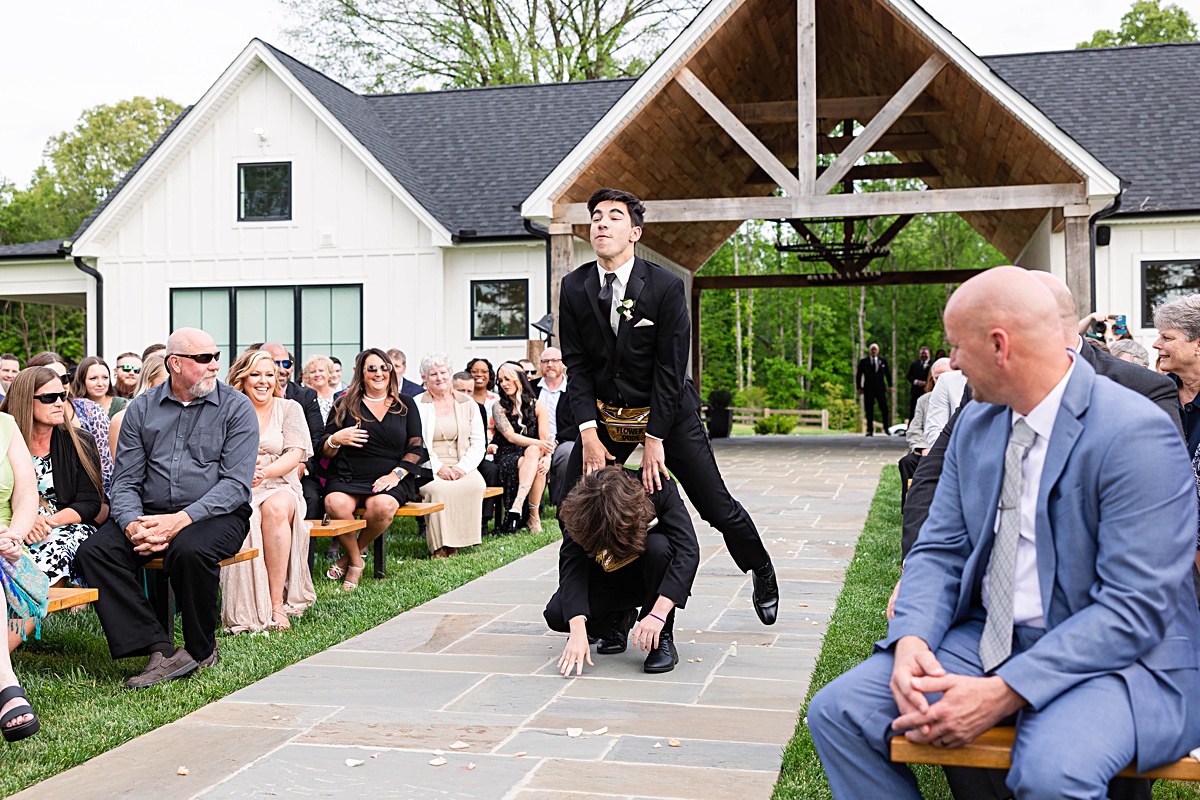 This elegant garden wedding at Cedar Oaks Farm features a classic car, stunning ceremony mountain view, unique bridal details, a boxer puppy, and a surprise baby gender reveal cake!