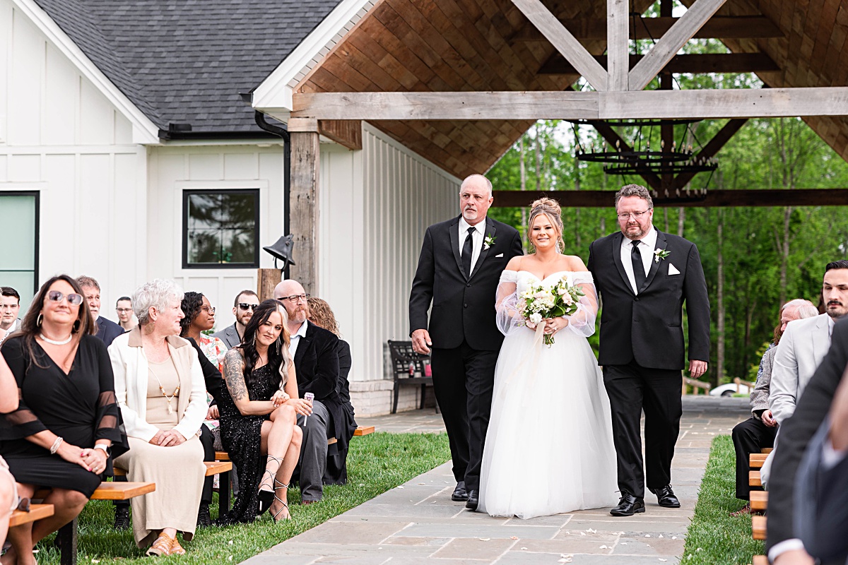 This elegant garden wedding at Cedar Oaks Farm features a classic car, stunning ceremony mountain view, unique bridal details, a boxer puppy, and a surprise baby gender reveal cake!