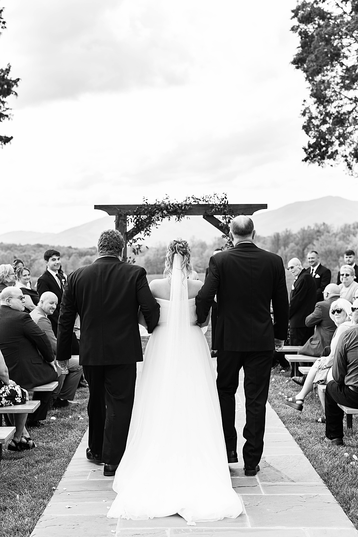 This elegant garden wedding at Cedar Oaks Farm features a classic car, stunning ceremony mountain view, unique bridal details, a boxer puppy, and a surprise baby gender reveal cake!