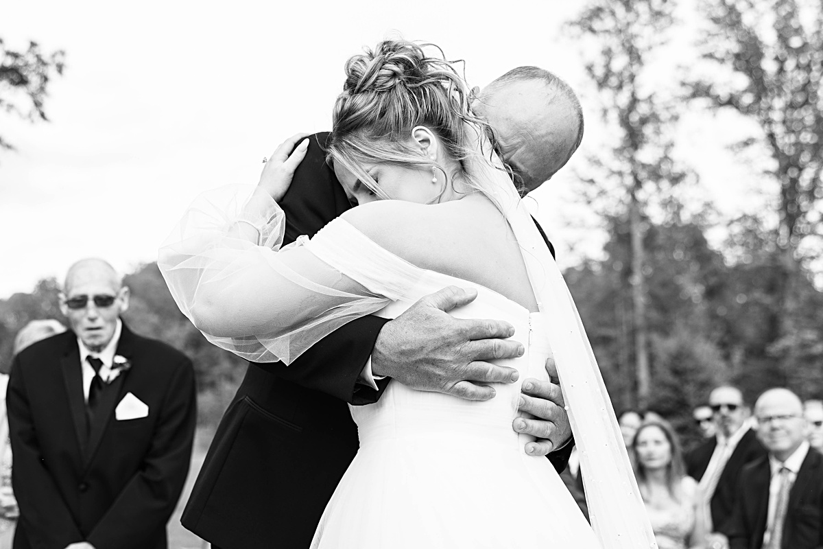 This elegant garden wedding at Cedar Oaks Farm features a classic car, stunning ceremony mountain view, unique bridal details, a boxer puppy, and a surprise baby gender reveal cake!