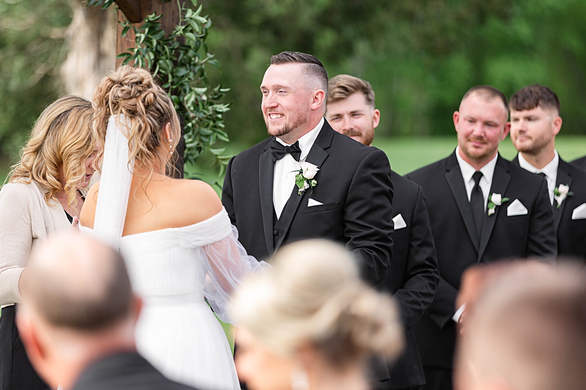 This elegant garden wedding at Cedar Oaks Farm features a classic car, stunning ceremony mountain view, unique bridal details, a boxer puppy, and a surprise baby gender reveal cake!