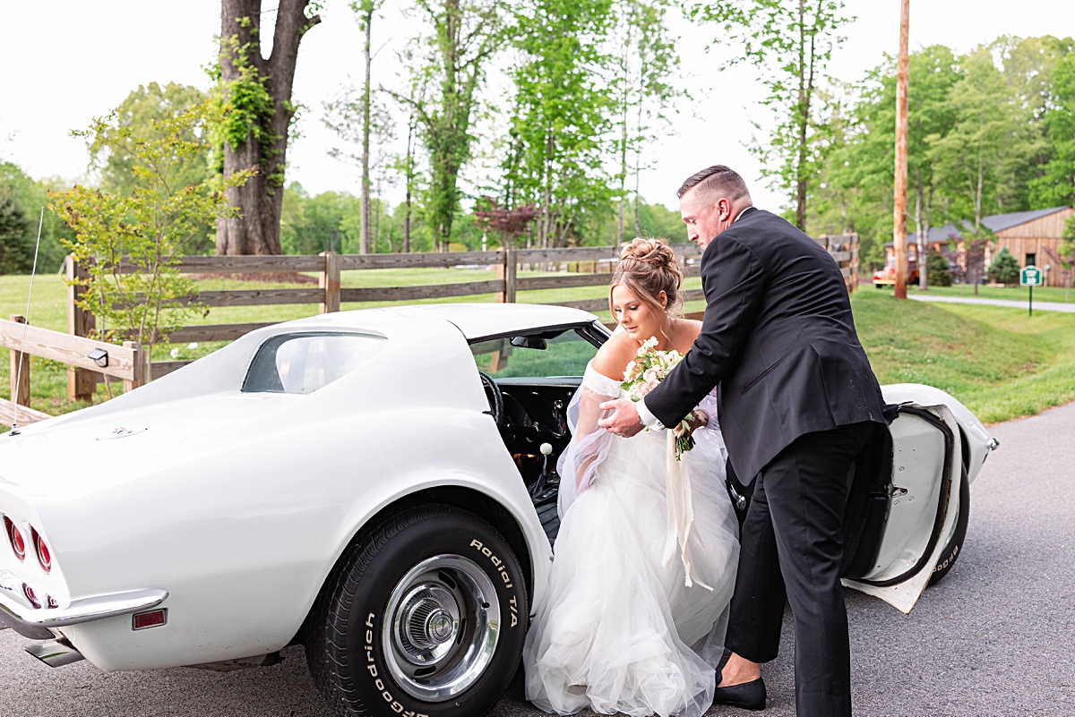 This elegant garden wedding at Cedar Oaks Farm features a classic car, stunning ceremony mountain view, unique bridal details, a boxer puppy, and a surprise baby gender reveal cake!