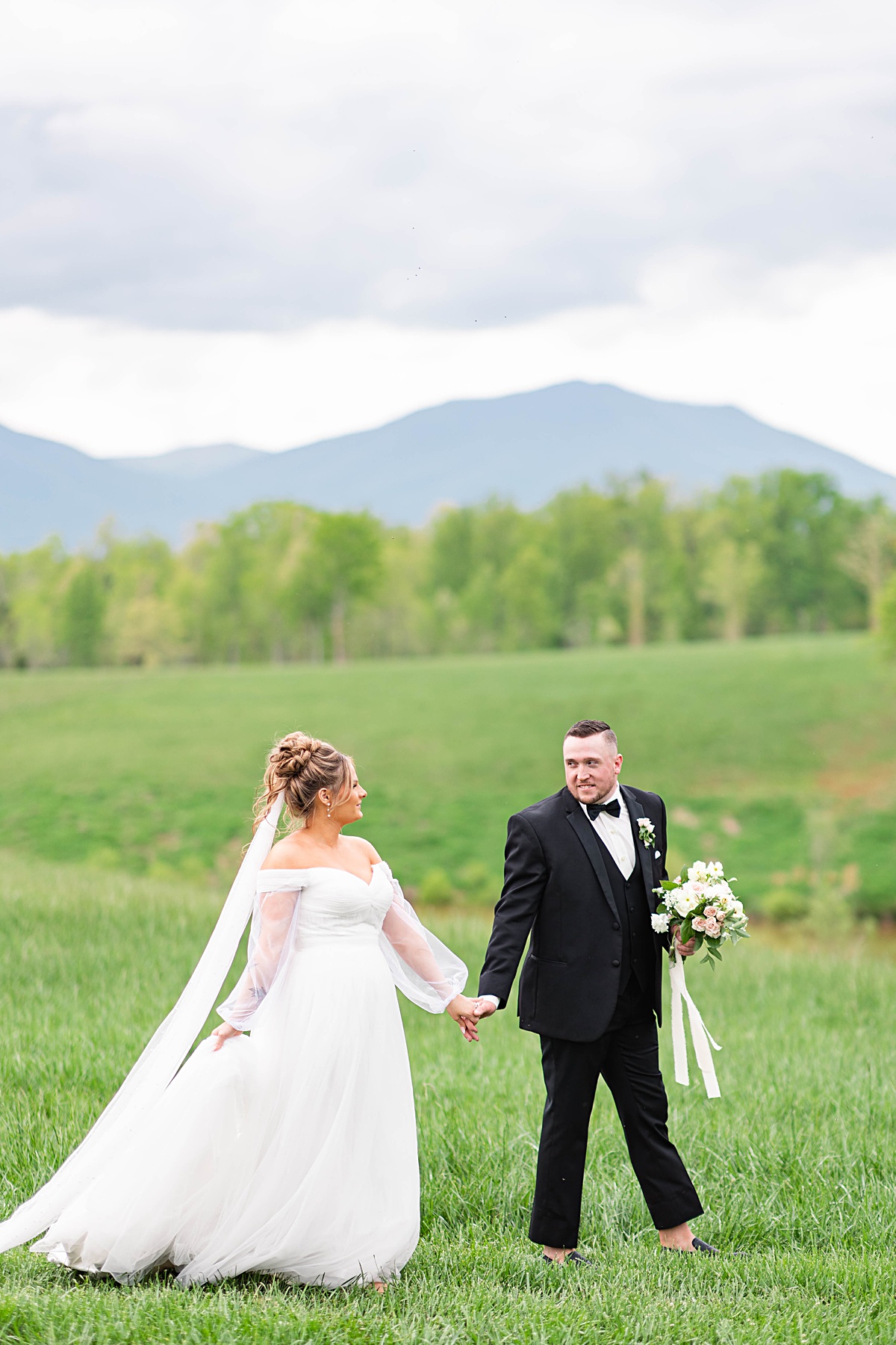 This elegant garden wedding at Cedar Oaks Farm features a classic car, stunning ceremony mountain view, unique bridal details, a boxer puppy, and a surprise baby gender reveal cake!