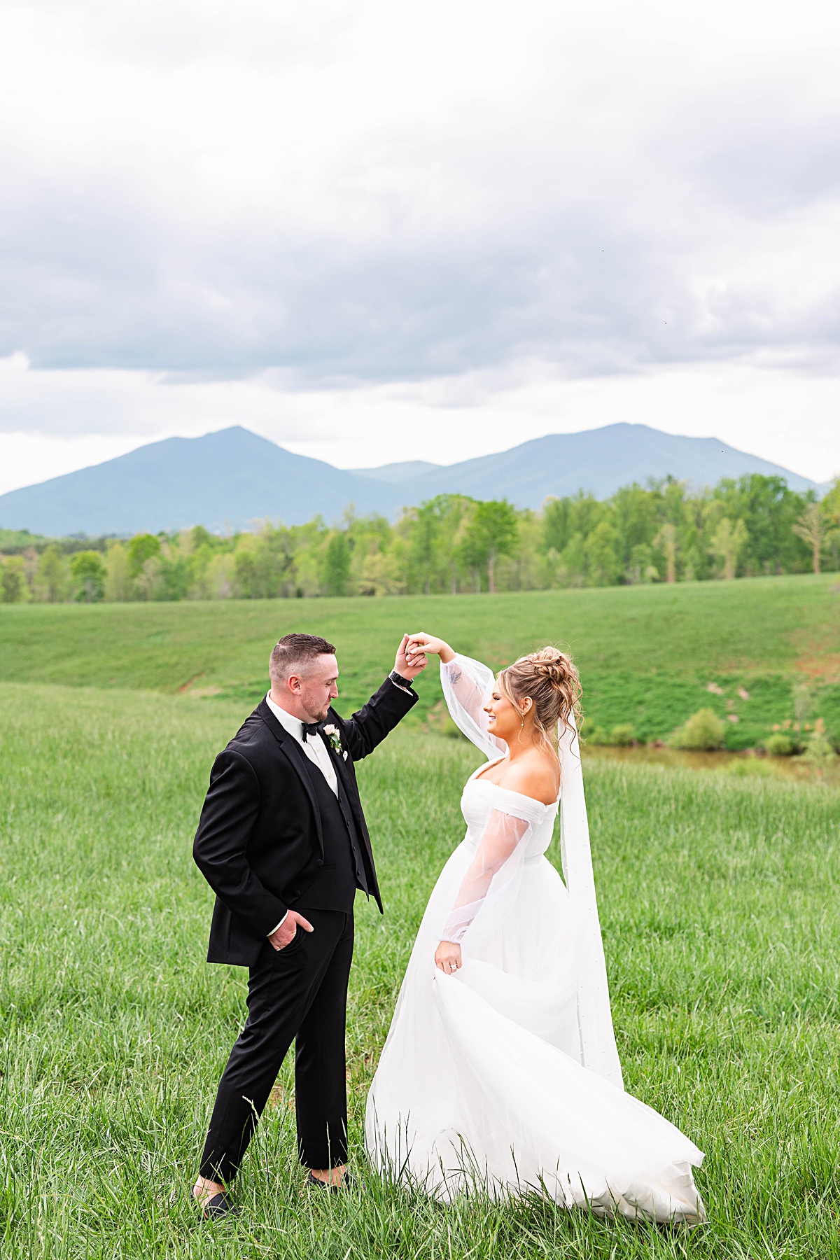 This elegant garden wedding at Cedar Oaks Farm features a classic car, stunning ceremony mountain view, unique bridal details, a boxer puppy, and a surprise baby gender reveal cake!