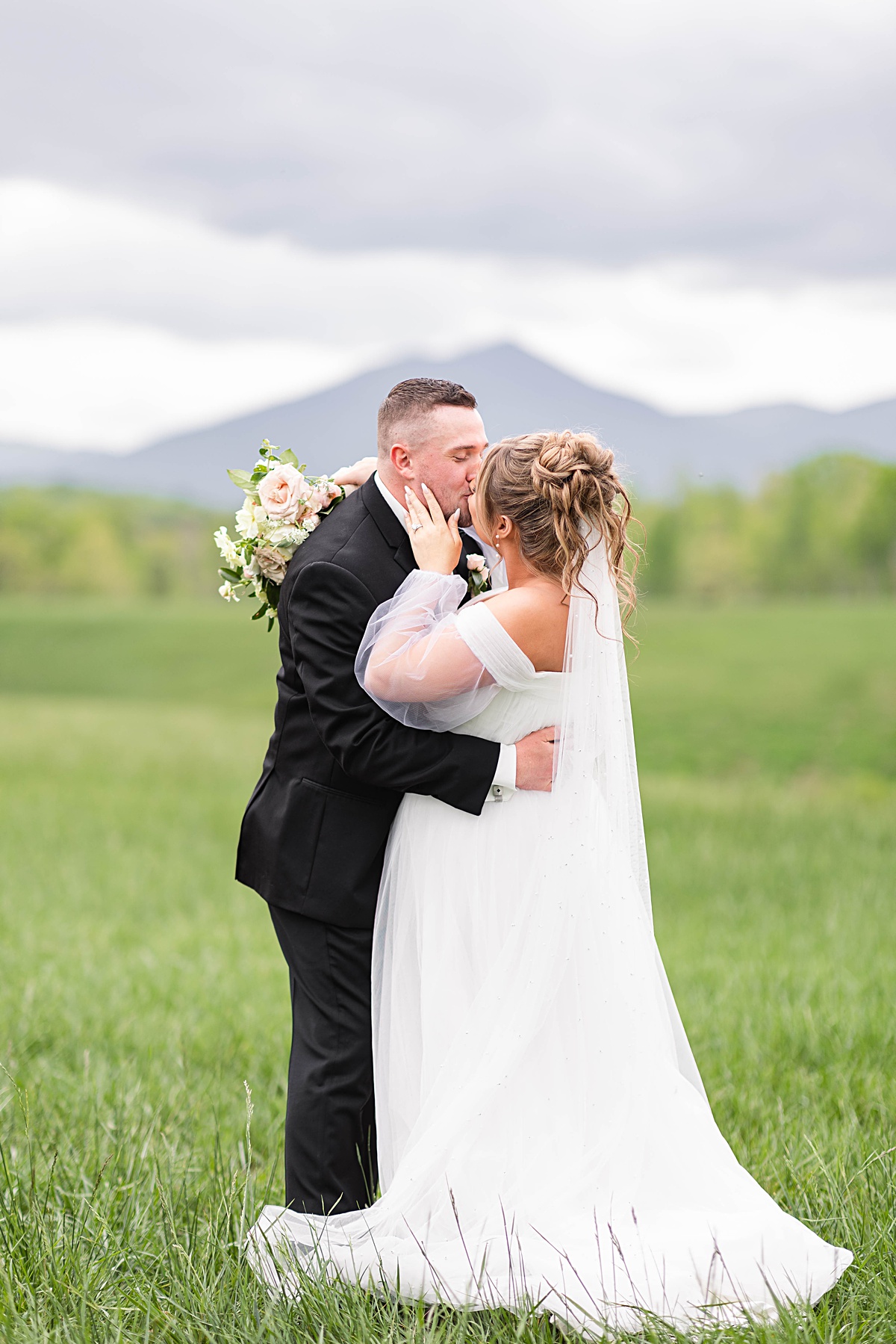 This elegant garden wedding at Cedar Oaks Farm features a classic car, stunning ceremony mountain view, unique bridal details, a boxer puppy, and a surprise baby gender reveal cake!