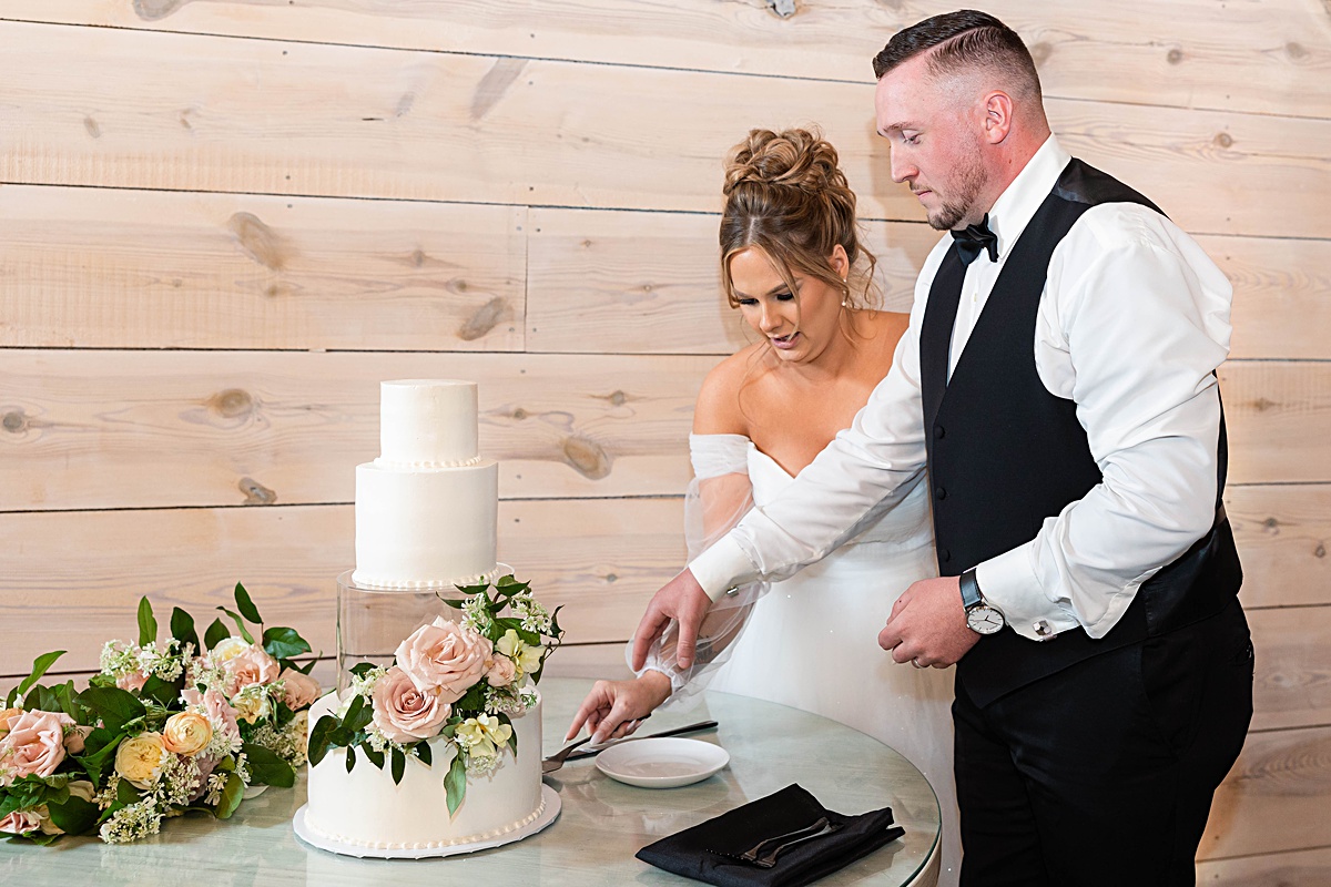 This elegant garden wedding at Cedar Oaks Farm features a classic car, stunning ceremony mountain view, unique bridal details, a boxer puppy, and a surprise baby gender reveal cake!