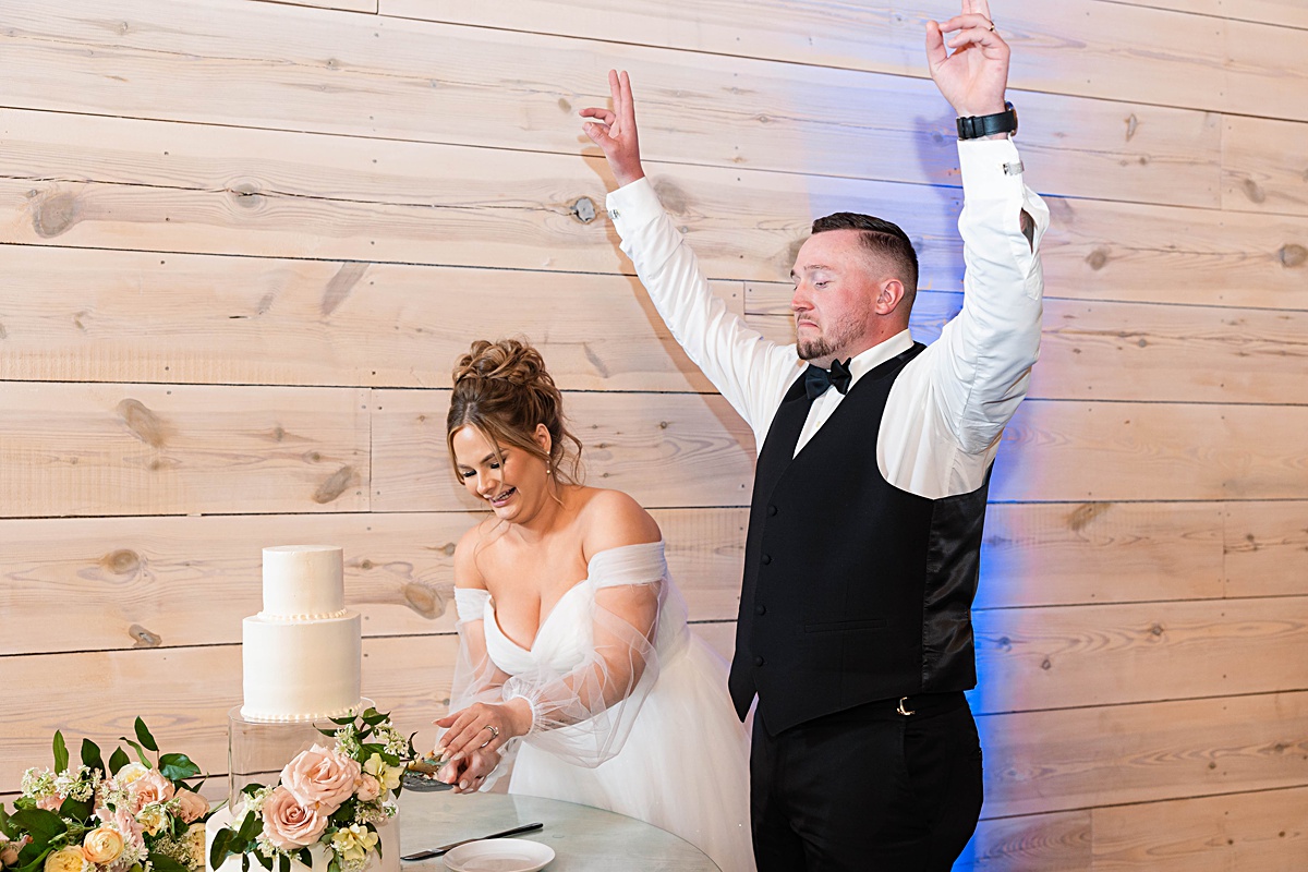 This elegant garden wedding at Cedar Oaks Farm features a classic car, stunning ceremony mountain view, unique bridal details, a boxer puppy, and a surprise baby gender reveal cake!