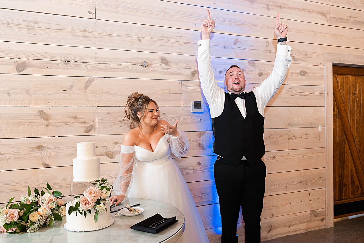 This elegant garden wedding at Cedar Oaks Farm features a classic car, stunning ceremony mountain view, unique bridal details, a boxer puppy, and a surprise baby gender reveal cake!