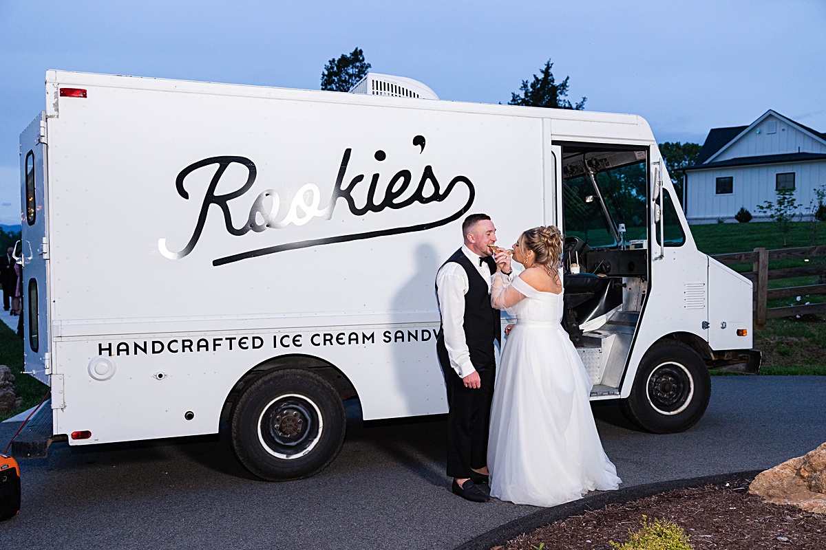 This elegant garden wedding at Cedar Oaks Farm features a classic car, stunning ceremony mountain view, unique bridal details, a boxer puppy, and a surprise baby gender reveal cake!