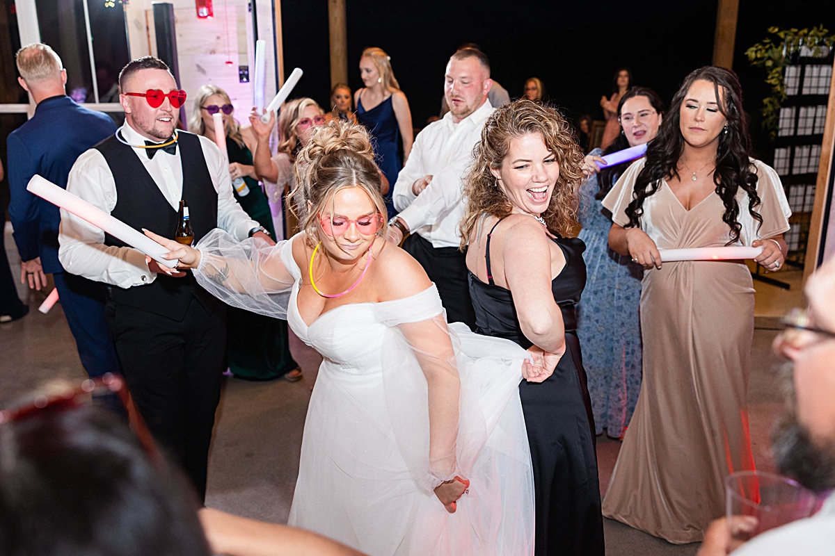 This elegant garden wedding at Cedar Oaks Farm features a classic car, stunning ceremony mountain view, unique bridal details, a boxer puppy, and a surprise baby gender reveal cake!