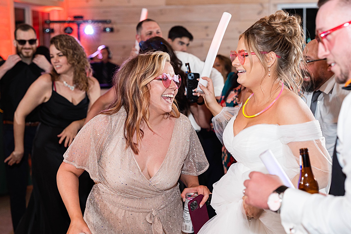 This elegant garden wedding at Cedar Oaks Farm features a classic car, stunning ceremony mountain view, unique bridal details, a boxer puppy, and a surprise baby gender reveal cake!