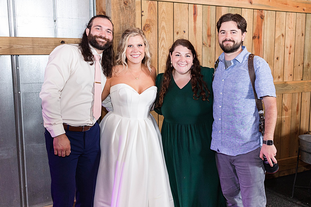 The bride and groom group photo with their photographers, James and Emily, at this Richmond, Virginia rustic spring garden wedding at Running Mare Farm.